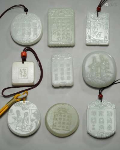 A group of nine Chinese white and pale celadon jade plaques