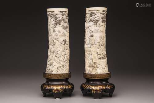 A pair of Japanese carved tusks with wooden base