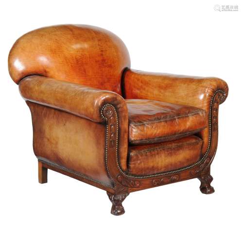 A pair of carved mahogany and leather upholstered armchairs