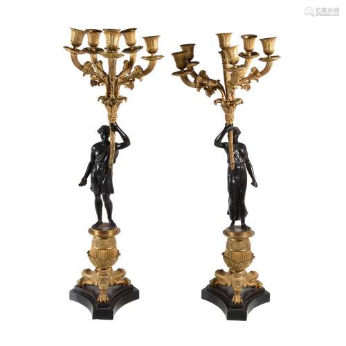 A pair of gilt and patinated bronze six light figural candelabra in Restauration style