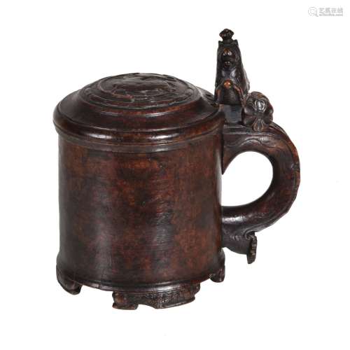 A Scandinavian carved and stained birch peg tankard