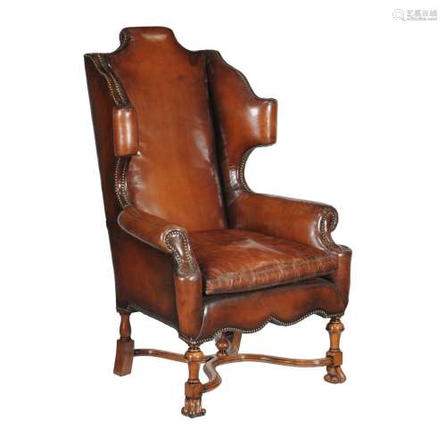 A walnut and studded leather upholstered armchair