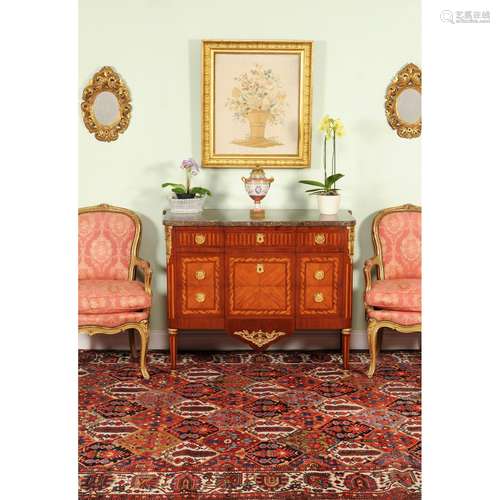 A French mahogany, parquetry, inlaid and gilt metal mounted commode in Louis XVI style