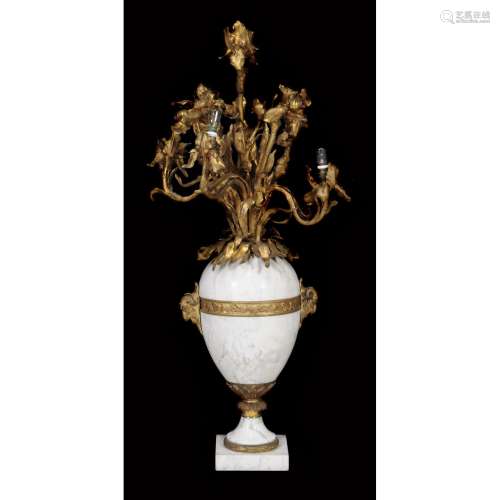 A French gilt metal mounted white marble six light table candelabrum modelled as a vase of flowers