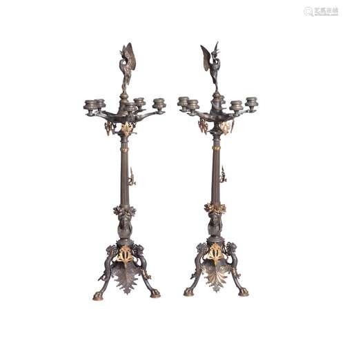 A pair of French patinated and gilt bronze five light candelabra