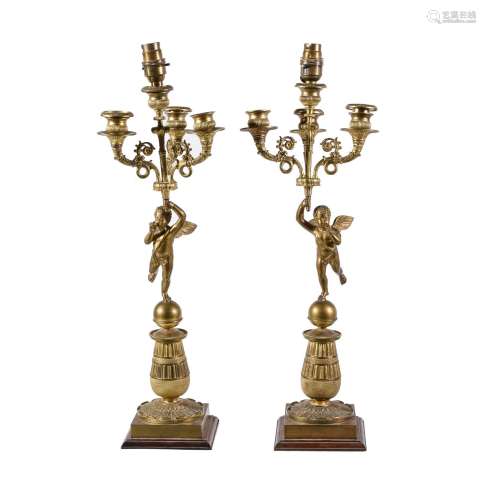 A pair of Empire gilt bronze four light figural candelabra