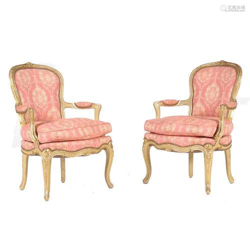 A pair of cream painted and parcel gilt armchairs, in Louis XV style