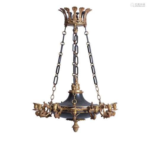 A patinated and gilt bronze twelve light chandelier in Empire style