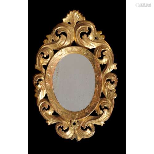 A pair of Continental carved giltwood oval wall mirrors