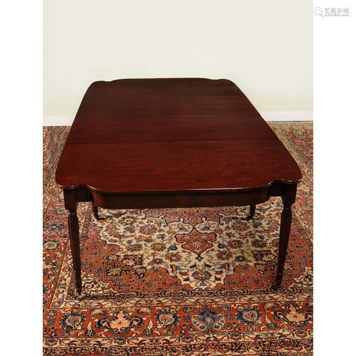 A George III plum pudding mahogany extending dining table