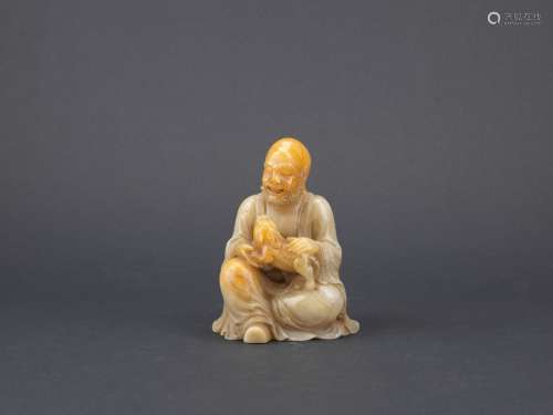 A soapstone carving of tiger taming arhat