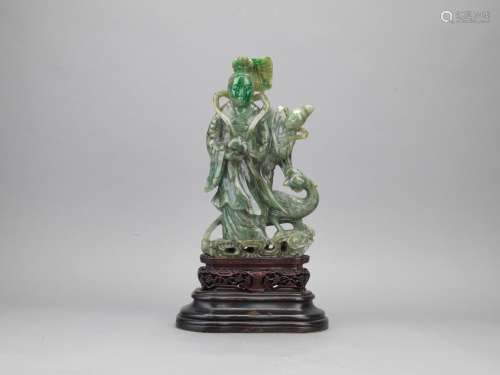 A large jadeite carved 'magu' figure on stand
