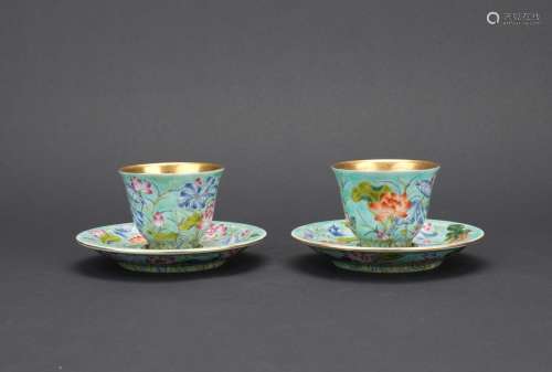 A pair of famille rose 'lotus' cups and holders