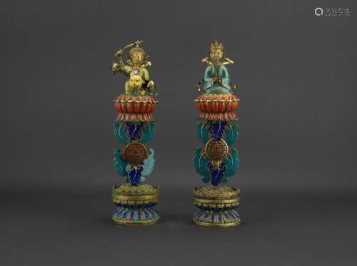 A pair of bronze enamelled 'figures' ritual objects