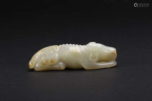 A celadon and russet jade recumbent dog