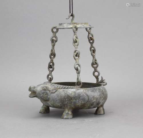 An archaic bronze 'ox' candle hanging vessel