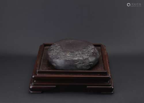 A very large inkstone with hardwood stand