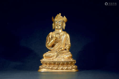 A gilt-bronze figure of guru