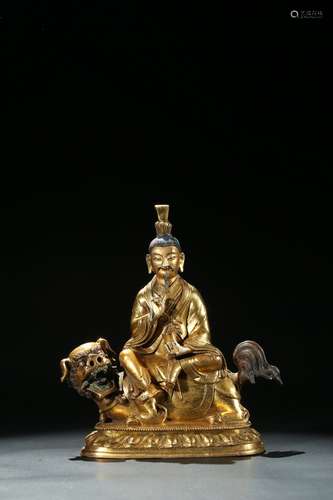 A gilt bronze figure of Manjusri and lion