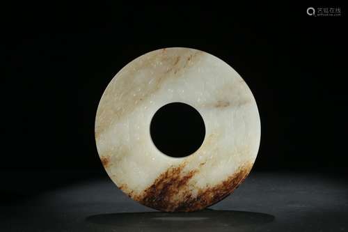 A white and russet jade carved 'mythical beast' disc