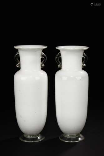 A pair of white glass vases