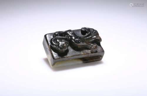 A black and white jade 'chilong' scabbard slide