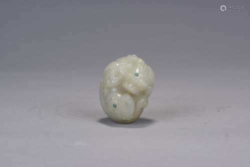 A white jade turquoise inlaid mythical beast