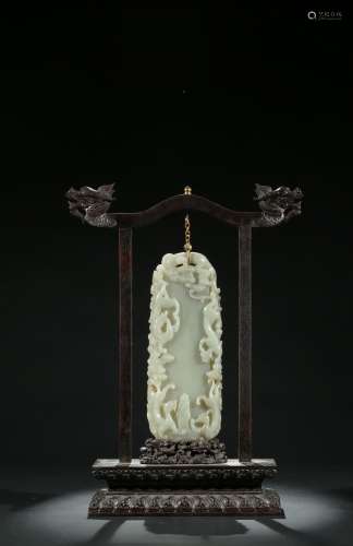 A Chinese celadon jade 'chilong' hanging pendant with stand