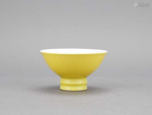 A lemon-yellow glazed cup