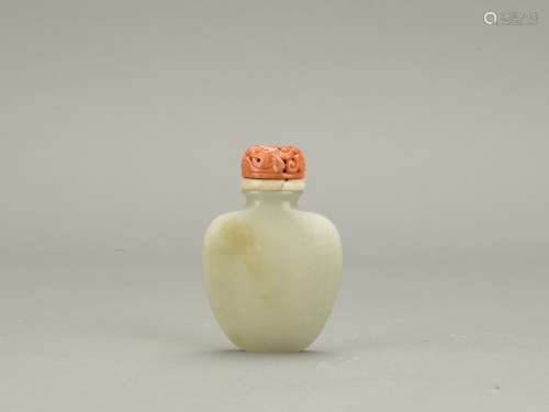 A white jade 'sash tied' snuff bottle with coral stopper