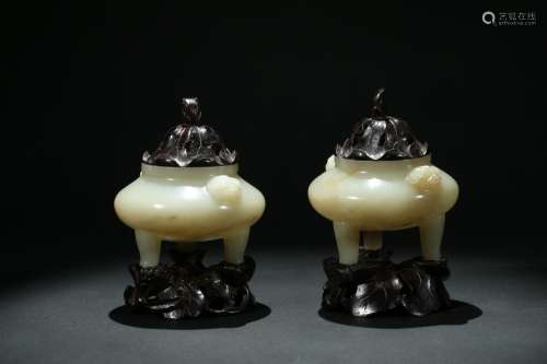 A pair of white jade tripod censers with zitan cover stand