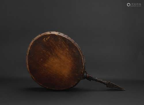 A large Tibetan ritual drum with vajra handle