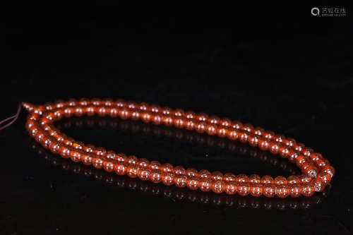 A STRING OF AMBER ROSARY BEADS