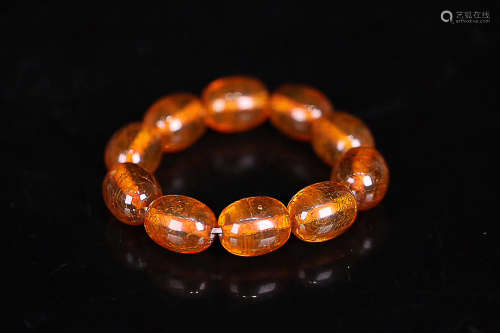 A STRING OF AMBER DATE SHAPED BEADS QING DYNASTY