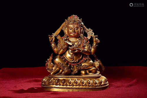 A GILT BRONZE FOUR-ARM MAHAKALA BUDDHA FIGURE