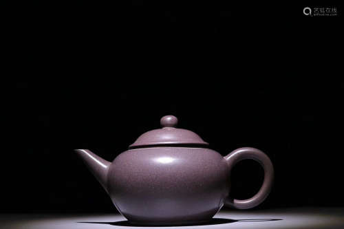 AN OLD PURPLE CLAY TEAPOT