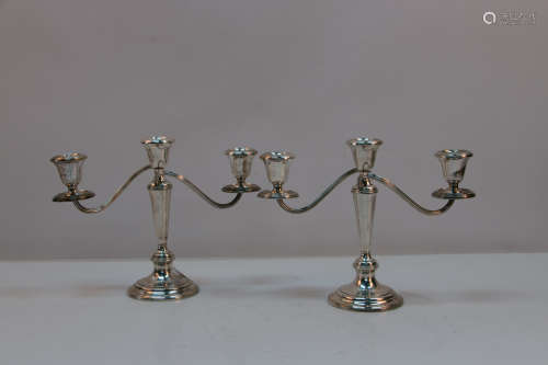 A pair of silver candle holders