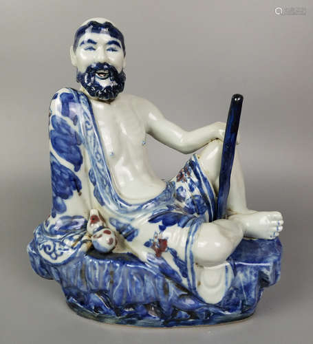 A BLUE AND WHITE BUDDHA FIGURE