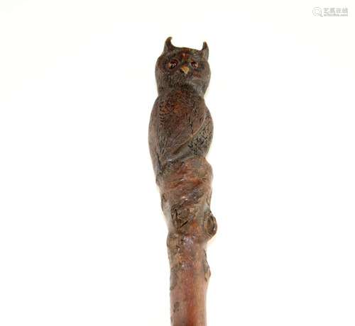 A blackthorn walking cane carved with an owl with