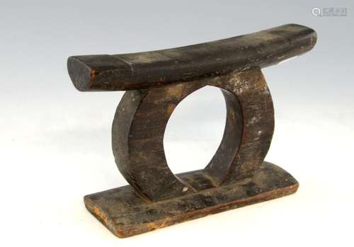 African carved wood headrest, on an 'O'-form stand