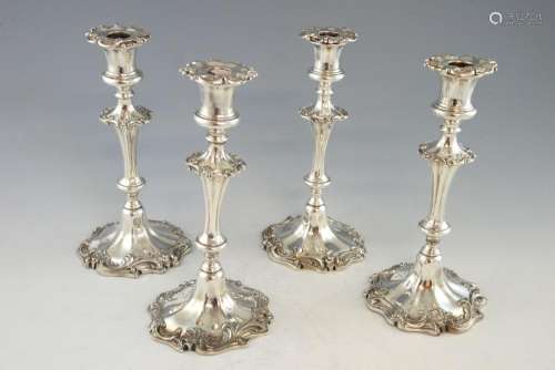 Four George III-style silver-plated candlesticks,
