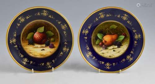 Pair of Coalport plates painted with still life of