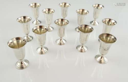 Modern set of twelve sterling silver tot cups, 7.5