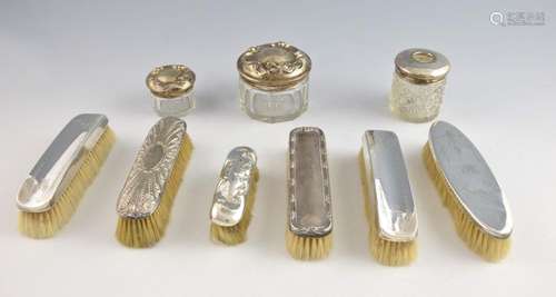 Six silver backed dressing table brushes and three