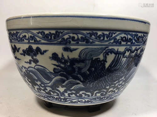 A BLUE AND WHITE SEA DESIGN GRAGON GRAIN VAT