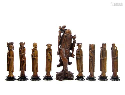 Early 20th century A set of boxwood Immortals and a single wood figure of Shoulao