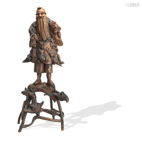 Late 19th/early 20th century A large rootwood carved figure of a fisherman on branch platform