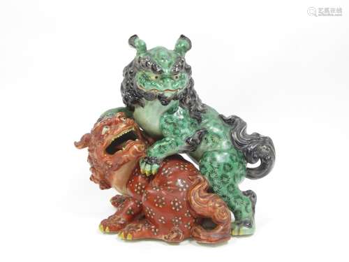 Meiji era, 19th century A porcelain figure group of two fighting shishi dogs