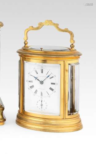 A good late 19th century French gilt brass oval grande sonnerie and repeating carriage clock with alarm, case and key Numbered 2184 2
