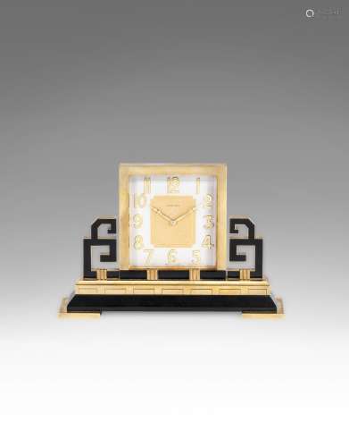 A mid 20th century gilt brass and black enamel desk timepiece Cartier